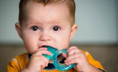 Baby teething with toy